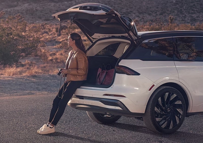 The All-new 2024 Lincoln Nautilus® SUV woman sits with trunk open